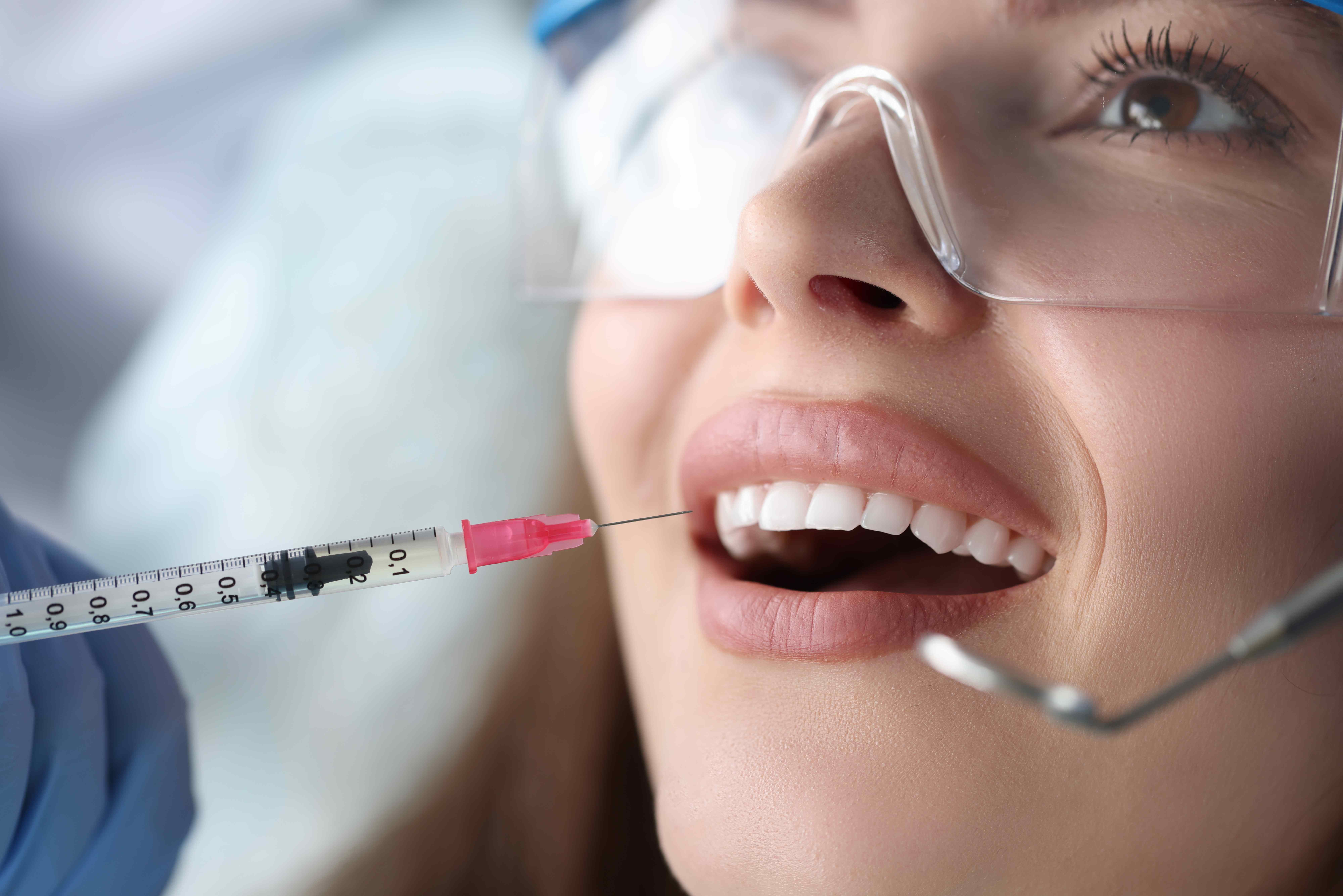 Woman sharing healthy smile after dental checkup and teeth cleaning